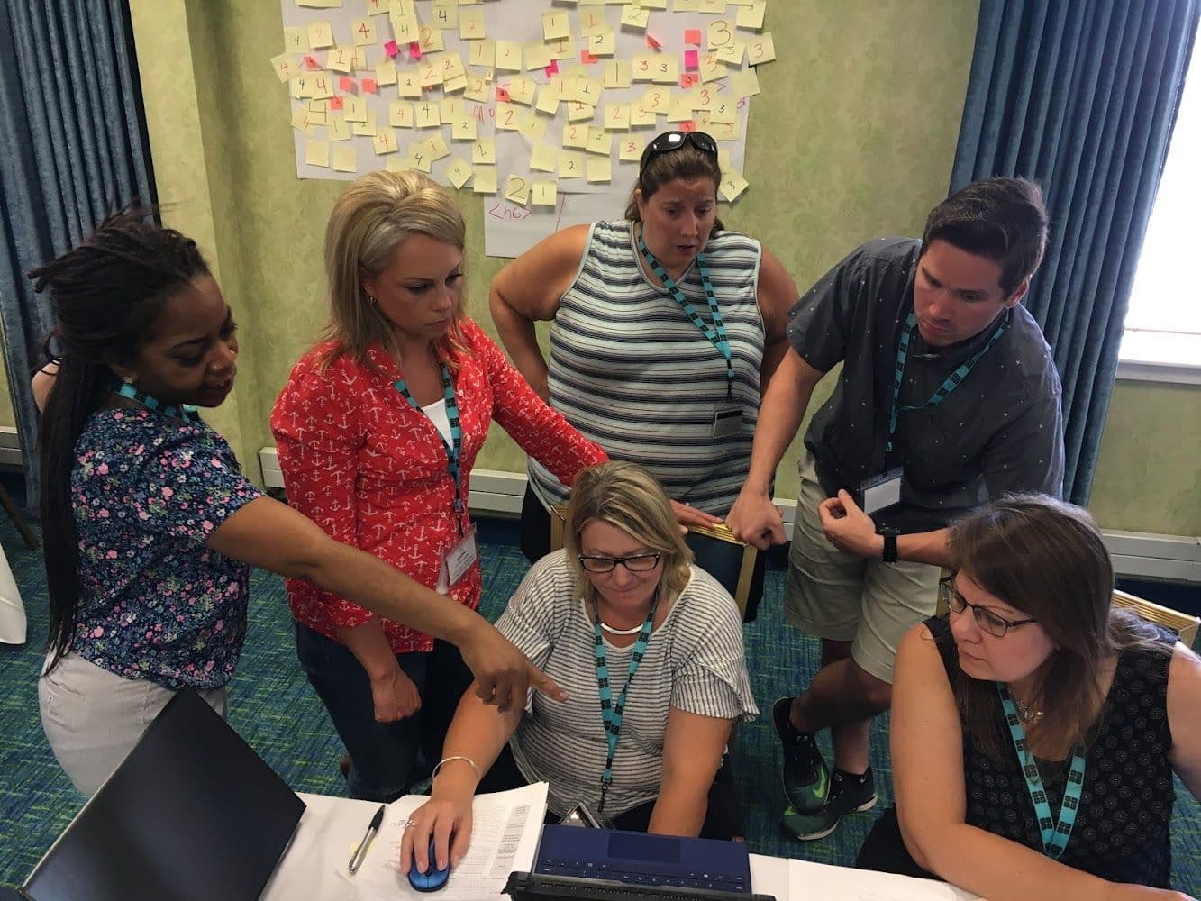 Teachers Gathered Around Computer Learning